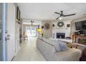 Spacious living room featuring a stone fireplace, ceiling fan, and ample seating at 4247 Windward Ln, Norcross, GA 30093