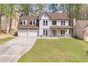 Charming two-story home with a three car garage, covered porch, and landscaped front yard at 539 Riverbirch Trce, Stone Mountain, GA 30087