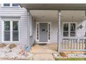 Inviting front porch with a hanging swing, decorative gravel, and stylish front door at 539 Riverbirch Trce, Stone Mountain, GA 30087