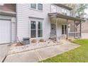 Cozy covered front porch with a swing, decorative gravel bed, and lovely front door at 539 Riverbirch Trce, Stone Mountain, GA 30087