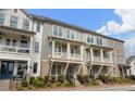 Charming townhomes with brick accents, inviting porches, and meticulously manicured landscaping at 825 Maplewood Dr, Roswell, GA 30075