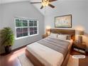 Cozy bedroom featuring a comfortable bed, stylish decor, and a large window with a view at 409 Kenley Ct, Mcdonough, GA 30253