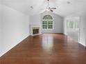 Bright living room with vaulted ceilings, large windows, and fireplace at 409 Kenley Ct, Mcdonough, GA 30253