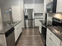 Modern kitchen featuring granite countertops and stainless steel appliances at 6615 Bluffview Dr, Douglasville, GA 30134