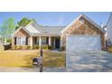Attractive house with stone accents, black shutters, manicured lawn, and convenient mailbox at 3851 Bogan Mill Rd, Buford, GA 30519