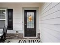 Close-up of a welcoming front door with decorative accents and a sidelight window at 531 S Fortune Way, Dallas, GA 30157