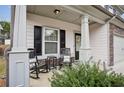 Inviting front porch featuring rocking chairs and a small table, perfect for relaxing outdoors at 531 S Fortune Way, Dallas, GA 30157