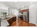 Updated kitchen featuring stainless steel appliances and granite countertops at 6270 Shiloh Woods Dr, Cumming, GA 30040