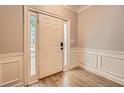 Inviting foyer showcasing hardwood floors, wainscoting, and a stylish front door with sidelights at 7155 Roswell Rd # 15, Atlanta, GA 30328