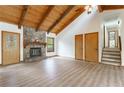 View of the living room featuring a stone fireplace, wood ceiling, and staircase at 1150 Autumn Ridge Dr, Marietta, GA 30066