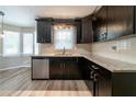 Spacious kitchen featuring granite countertops, dark cabinets, and stainless steel appliances at 1171 Bailing Dr, Lawrenceville, GA 30043
