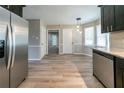 Open kitchen with stainless steel appliances, dining nook, and light wood flooring at 1171 Bailing Dr, Lawrenceville, GA 30043