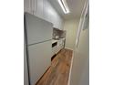 This kitchen features stainless appliances, white cabinets and wood flooring at 2805 Ne Ne Expressway Ne # B-26, Atlanta, GA 30345