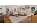 Bright living room with hardwood floors, area rug, comfortable seating, and natural light at 5725 Brenda Sw Dr, Mableton, GA 30126