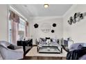 Sitting room featuring elegant decor, stylish seating arrangements, and a chic coffee table on dark wood floors at 15 Granville Ln, Covington, GA 30016