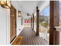 Inviting front porch features wooden deck, ceiling fan, and stylish outdoor lighting at 770 Waters Sw Dr, Atlanta, GA 30310