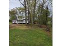 Beautiful large yard with mature trees, and well-manicured lawn at 4620 Oak Grove Cir, Cumming, GA 30028