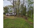 Beautiful large yard with mature trees, and well-manicured lawn at 4620 Oak Grove Cir, Cumming, GA 30028