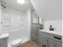 Bathroom with white shower, gray vanity, gray flooring, and modern fixtures at 7965 Tower Dr, Douglasville, GA 30134