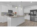 Modern kitchen features white cabinets, granite countertops, stainless steel appliances and large center island at 70 Clark Lake Ln, Grayson, GA 30017