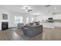 Bright and open living room featuring hardwood floors, a fireplace, and a comfortable seating area at 70 Clark Lake Ln, Grayson, GA 30017