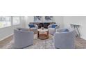 Cozy sitting area with gray armchairs, accent table, and modern art, perfect for relaxation and conversation at 70 Clark Lake Ln, Grayson, GA 30017