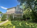 Inviting two-story home featuring a covered porch and verdant front yard with manicured bushes at 1326 Mcpherson Ave., Atlanta, GA 30316
