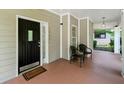 Inviting front porch with seating area, decorative door, and views of the landscaped yard at 1326 Mcpherson Ave., Atlanta, GA 30316