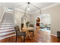 Open-concept living space with hardwood floors, staircase, and decorative archways to other rooms at 1326 Mcpherson Ave., Atlanta, GA 30316
