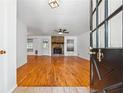View of the living room with hardwood floors and a stone fireplace as seen from the front door at 2341 Cedar Dr, Lawrenceville, GA 30043