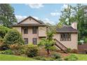 Beautiful home featuring a wood exterior, well-kept lawn, and flourishing landscaping at 3730 Willow Mill Dr, Lawrenceville, GA 30044