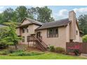 Inviting home exterior with wood siding, mature trees, and meticulously landscaped yard at 3730 Willow Mill Dr, Lawrenceville, GA 30044