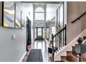 Stunning foyer with hardwood floors, large windows, and staircase leading to a second floor at 6990 Annie Walk, Lithonia, GA 30038