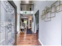 Inviting foyer with rich hardwood floors, wrought iron banister, and soaring ceilings creating a grand entrance at 6990 Annie Walk, Lithonia, GA 30038