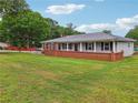 Exterior shot of a lovely single-story home, complete with a well-manicured lawn at 815 Tanner Rd, Dacula, GA 30019