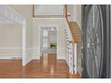 Bright foyer with hardwood floors, staircase, and views into adjacent rooms, creating an inviting entrance at 1405 Wilmington Way, Grayson, GA 30017