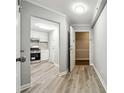 Hallway with gray wood floors connects the entryway to the kitchen and other areas of the home at 1501 Clairmont Rd # 1624, Decatur, GA 30033