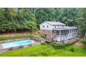 Expansive backyard featuring a private pool, lush greenery, and a screened porch, ideal for outdoor living at 2940 Blue Sky Pl, Marietta, GA 30068