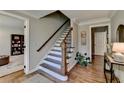 Spacious foyer with hardwood floors, staircase with wood and iron banister, and views into other rooms at 5023 Buckline Xing, Dunwoody, GA 30338