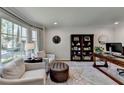 Bright home office featuring a large bay window, built-in bookcase, and comfortable seating area at 5023 Buckline Xing, Dunwoody, GA 30338
