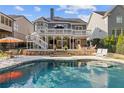 Resort-style backyard with a refreshing pool, spacious deck, and lush landscaping perfect for outdoor entertaining at 5724 Kendrick Ln, Cumming, GA 30041