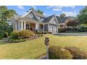 Beautiful home with lush landscaping and a charming front porch, showcasing curb appeal at 5724 Kendrick Ln, Cumming, GA 30041
