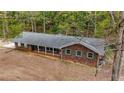 Classic ranch-style home with brick facade, complemented by green shutters and a covered front porch at 285 Glen Ne Rd, Conyers, GA 30013