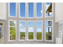 Bright living room with a wall of windows offering stunning views of the lush landscape at 322 Tupelo Tr Trl, Canton, GA 30114