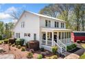Charming home exterior with a screened in porch, mature landscaping, and stone walkway at 4504 Union Hill Rd, Canton, GA 30115
