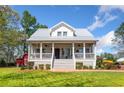 Inviting home exterior featuring a covered porch with white railings and a well-maintained lawn at 4504 Union Hill Rd, Canton, GA 30115