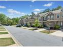 Exterior street view of a row of townhouses with well-manicured lawns at 5157 Madeline, Stone Mountain, GA 30083