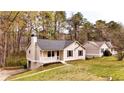 Cozy one-story home featuring a covered porch and a manicured lawn at 6092 Leverett Dr, Lithonia, GA 30038