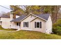 Charming one-story home with black shutters and well-maintained lawn at 6092 Leverett Dr, Lithonia, GA 30038