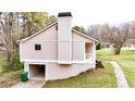 Side view of house with an open garage and neatly trimmed grass at 6092 Leverett Dr, Lithonia, GA 30038